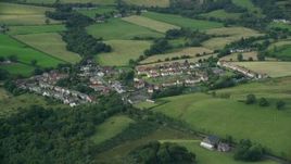 5.5K aerial stock footage of rural homes surrounded by farmland, Cumbernauld, Scotland Aerial Stock Footage | AX110_233