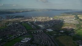 5.5K aerial stock footage of a natural gas power plant beside the water, Falkirk, Scotland Aerial Stock Footage | AX111_010