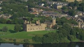 5.5K aerial stock footage of Linlithgow Palace and St. Michael's Parish Church, Scotland Aerial Stock Footage | AX111_011E