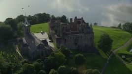 5.5K aerial stock footage of an orbit around historic Linlithgow Palace and St. Michael's Parish Church, Linlithgow, Scotland Aerial Stock Footage | AX111_018E