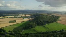 5.5K aerial stock footage of farm fields and trees, South Queensferry, Scotland Aerial Stock Footage | AX111_092E