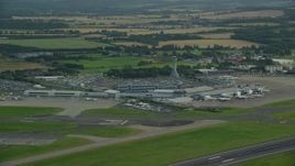5.5K aerial stock footage of the Edinburgh Airport and farmland, Scotland Aerial Stock Footage | AX111_105E