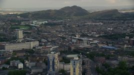 5.5K aerial stock footage of the Easter Road soccer stadium and Arthur's Seat mountain peak, Edinburgh, Scotland Aerial Stock Footage | AX111_123E