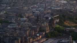 5.5K aerial stock footage of passing by The Hub and Edinburgh Castle, Scotland at sunset Aerial Stock Footage | AX112_016E