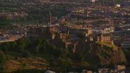 5.5K aerial stock footage of a view of Edinburgh Castle in Scotland at sunset Aerial Stock Footage | AX112_040E