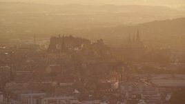 5.5K aerial stock footage of iconic Edinburgh Castle and Arthur's Seat, Scotland during hazy sunset Aerial Stock Footage | AX112_065E