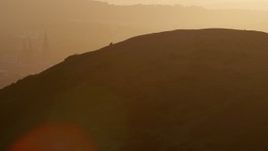 5.5K aerial stock footage of Edinburgh Castle seen from Arthur's Seat, Scotland at sunset Aerial Stock Footage | AX112_070E