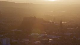 5.5K aerial stock footage slowly flyby Edinburgh Castle and The Hub cathedral, Scotland at sunset Aerial Stock Footage | AX112_073E