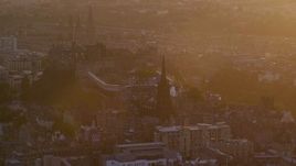 5.5K aerial stock footage of passing iconic Edinburgh Castle and The Hub cathedral, Scotland at sunset Aerial Stock Footage | AX112_075E