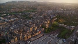 5.5K aerial stock footage of a wide view of the Edinburgh cityscape, Scotland at sunset Aerial Stock Footage | AX112_077