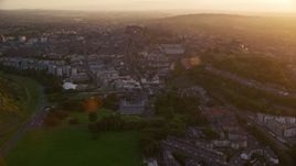 5.5K aerial stock footage of following Canongate toward Edinburgh Castle, Scotland at sunset Aerial Stock Footage | AX112_091E