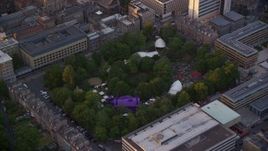 5.5K aerial stock footage of circling George Square Gardens with trees, University of Edinburgh, Scotland at sunset Aerial Stock Footage | AX112_101E