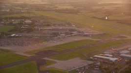 5.5K aerial stock footage of terminals and control tower of Edinburgh Airport, Scotland at sunset Aerial Stock Footage | AX112_116E