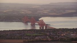 5.5K aerial stock footage of Forth Bridge spanning Firth of Forth, Edinburgh, Scotland at sunset Aerial Stock Footage | AX112_120E