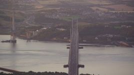 5.5K aerial stock footage of the Forth Road Bridge over the Firth of Forth, Edinburgh, Scotland at sunset Aerial Stock Footage | AX112_122E