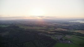 5.5K aerial stock footage of sun setting over farmland, Linlithgow, Scotland Aerial Stock Footage | AX112_135E