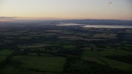 5.5K aerial stock footage of farmland near a power plant, Falkirk, Scotland at twilight Aerial Stock Footage | AX112_138