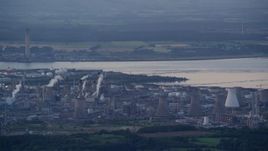 5.5K aerial stock footage flyby natural gas plant by the water, Falkirk, Scotland at twilight Aerial Stock Footage | AX112_144E