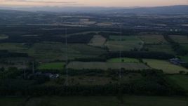 5.5K aerial stock footage orbit radio towers by farmland, Falkirk, Scotland at sunset Aerial Stock Footage | AX112_150