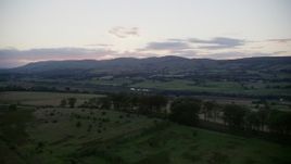 5.5K aerial stock footage of farmland in a rural landscape at twilight in Cumbernauld, Scotland Aerial Stock Footage | AX112_161