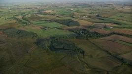 5.5K aerial stock footage of farms and farming fields, Kilmarnock, Scotland at sunrise Aerial Stock Footage | AX113_022E