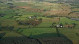 5.5K aerial stock footage of farm fields and rural homes, Kilmarnock, Scotland at sunrise Aerial Stock Footage | AX113_024E