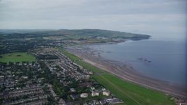 5.5K aerial stock footage fly over beachfront homes near Firth of Clyde in Ayr, Scotland Aerial Stock Footage | AX113_039E