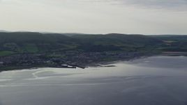 5.5K aerial stock footage of the coastal town of Girvan seen from Firth of Clyde, Scotland Aerial Stock Footage | AX113_070E