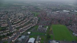 5.5K aerial stock footage of row houses and a small factory, Belfast, Northern Ireland Aerial Stock Footage | AX113_097E