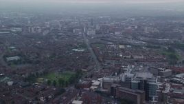 5.5K aerial stock footage follow Grosvenor Road toward office buildings, Belfast, Northern Ireland Aerial Stock Footage | AX113_099E