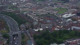 5.5K aerial stock footage of orbiting the Carlisle Circus roundabout by a church in Belfast, Northern Ireland Aerial Stock Footage | AX113_109E