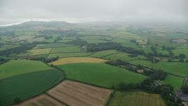 5.5K aerial stock footage of flying over farms and farmland toward Scrabo Tower, Newtownards, Northern Ireland Aerial Stock Footage | AX113_131
