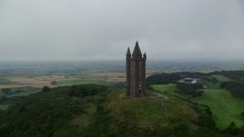 5.5K aerial stock footage of orbiting Scrabo Tower atop a green hill, Newtownards, Northern Ireland Aerial Stock Footage | AX113_137