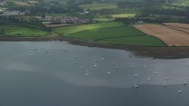 5.5K aerial stock footage of sailboats in the harbor and farmland along the shore, Strangford Lough, Northern Ireland Aerial Stock Footage | AX113_150