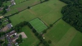 5.5K aerial stock footage tilt from farmland and reveal residential neighborhoods, Wallington, England Aerial Stock Footage | AX114_003E