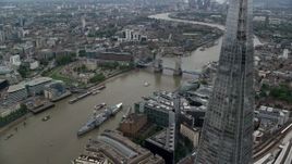 5.5K aerial stock footage of flying by The Shard skyscraper for view of Tower Bridge, London, England Aerial Stock Footage | AX114_023