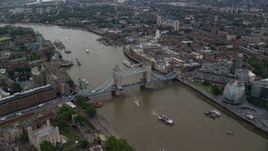 5.5K aerial stock footage tilt to a bird's eye view of the Tower Bridge over River Thames, London, England Aerial Stock Footage | AX114_050E