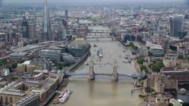 5.5K aerial stock footage orbit the Tower Bridge on River Thames near skyscrapers, Central London, England Aerial Stock Footage | AX114_093E