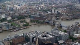 5.5K aerial stock footage of passing the Tower of London and Tower Bridge over the River Thames, England Aerial Stock Footage | AX114_119E