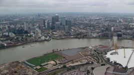 5.5K aerial stock footage orbit The O2 arena, with Canary Wharf skyscrapers in background, London, England Aerial Stock Footage | AX114_139E