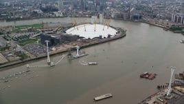5.5K aerial stock footage fly over O2 arena, approach Canary Wharf skyscrapers, London, England Aerial Stock Footage | AX114_145E