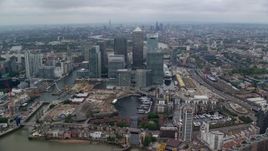 5.5K aerial stock footage fly over Canary Wharf skyscrapers toward River Thames, London, England Aerial Stock Footage | AX114_149E
