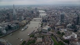 5.5K aerial stock footage of flying over London Bridge toward other bridges over the River Thames, England Aerial Stock Footage | AX114_160E