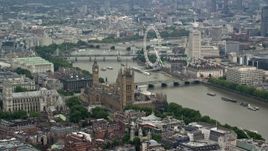 5.5K aerial stock footage of Big Ben, Parliament, and London Eye beside the River Thames, England Aerial Stock Footage | AX114_175