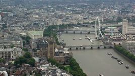 5.5K aerial stock footage of Big Ben, Parliament and London Eye on River Thames, England Aerial Stock Footage | AX114_176