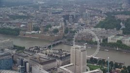 5.5K aerial stock footage of London Eye with Big Ben and British Parliament in the background, England Aerial Stock Footage | AX114_183E