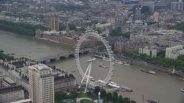 5.5K aerial stock footage fly over London Eye toward Big Ben and Parliament, England Aerial Stock Footage | AX114_185E