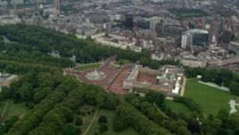 5.5K aerial stock footage orbit Buckingham Palace, tilt to reveal Big Ben and Parliament, London, England Aerial Stock Footage | AX114_211