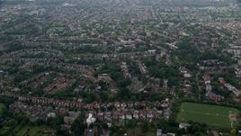5.5K aerial stock footage of residential neighborhoods and Saint Benedict's Abbey, London, England Aerial Stock Footage | AX114_276E