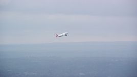 5.5K aerial stock footage tracking commercial jet while ascending from Heathrow Airport, England Aerial Stock Footage | AX114_292